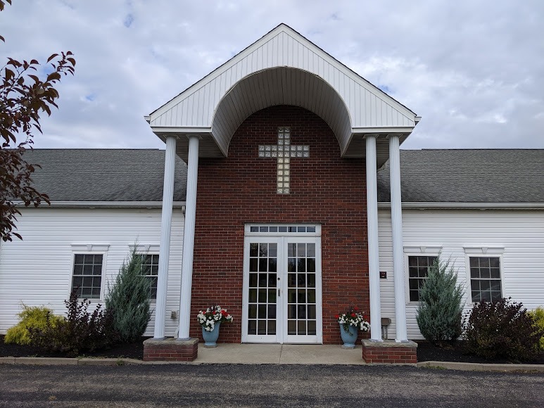 Front entrance of First Bible Baptist Church with its brick archway and cross